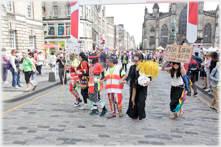 Line of costumed dancers on Royal Mile.