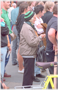 Woman in woolly hat in crowd.