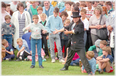 Performer introducing a boy to help him.