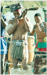 Man playing animal horn.