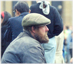 Bearded man in flat cap.