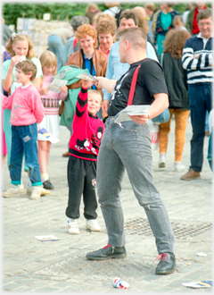 Man turns behind him to give a leaflet.