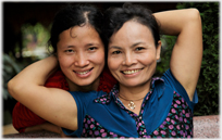 Two womens faces framed in one set of arms.