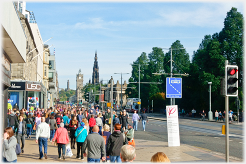 Looking east along Princes Street with the wide pavement crowded.