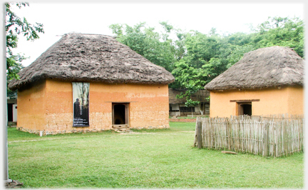 Two thatched adobe houses.