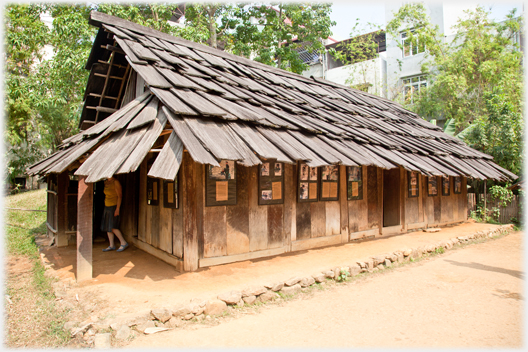 A house with large shingles on roof and walls.