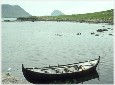 Boat with Koltur hill beyond.