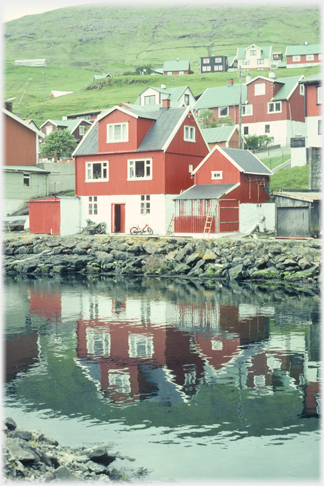 Red house by water.