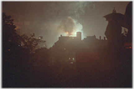 Flares behind buildings.