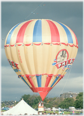 The Phileas Fogg balloon off the ground, marquee behind.