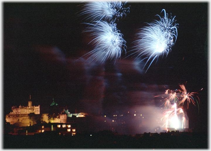 Blue fire bursts  with plumes below and castle lit up.