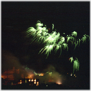 Green plumes above back lit buildings.