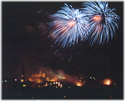 Two blue streaked fire bursts above castle.