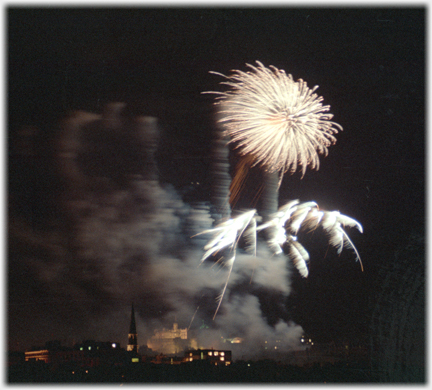 Large bronze coloured fire burst with plumes and castle below.