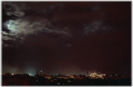 Edinburgh skyline with moon appearing from clouds