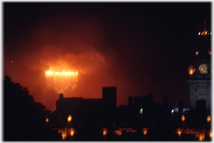 Red fireworks flowing over Castle wall.