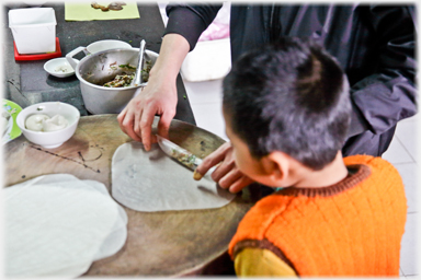 Child watching nem making.