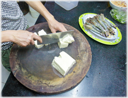 Cutting up tofu.