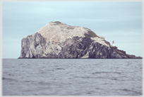 The Gannet encrusted Bass Rock.