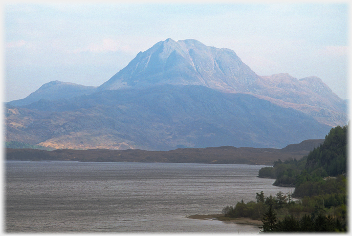 Closer view of the hill with its gullies and the loch in the foreground.