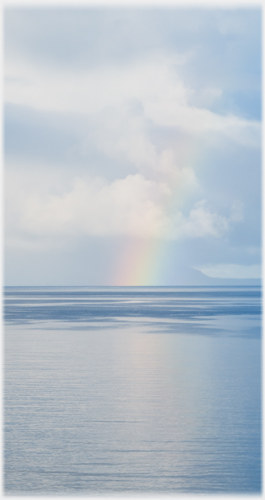 Sea horizon with rainbow toucing it.