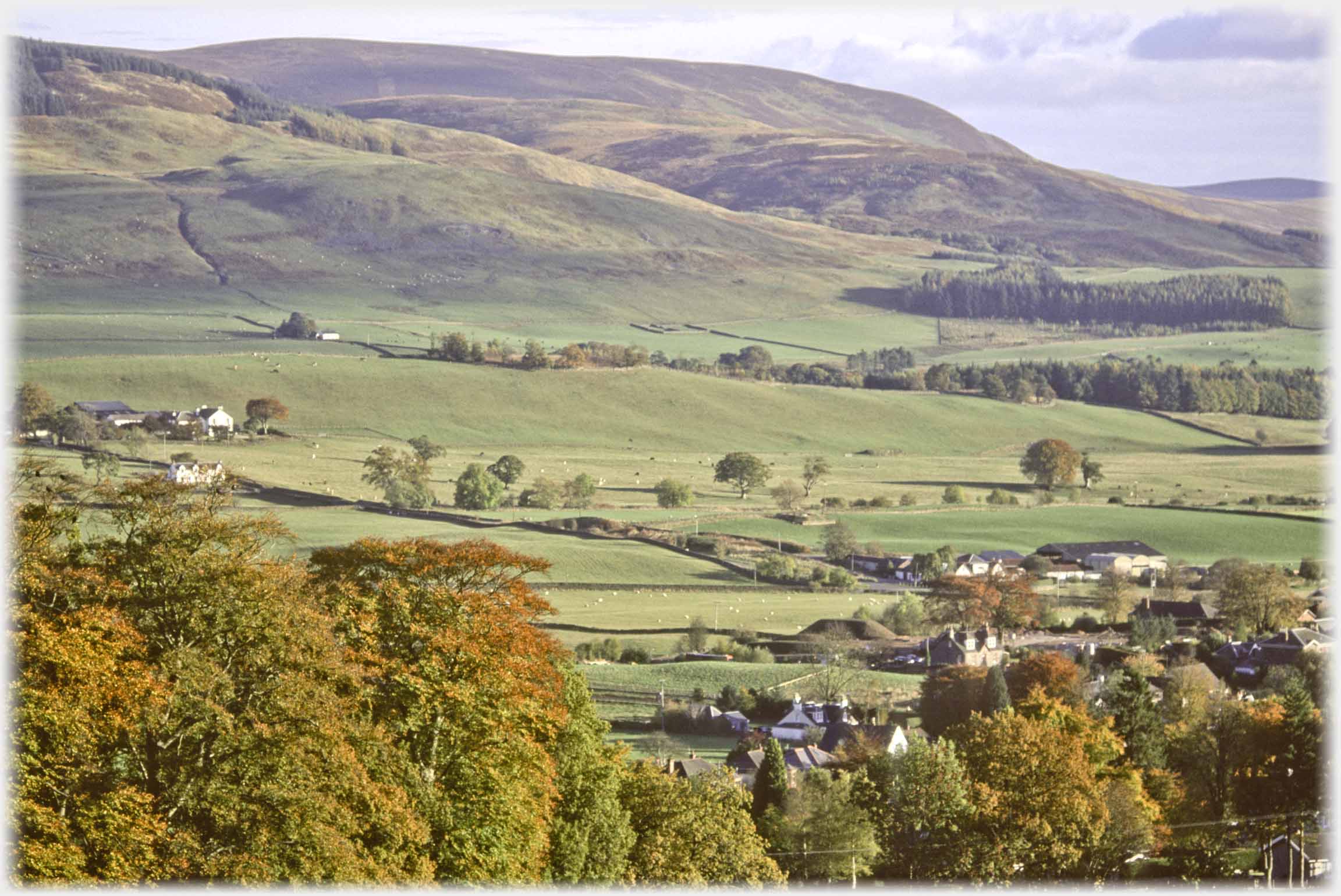 Hills running down to town edge.