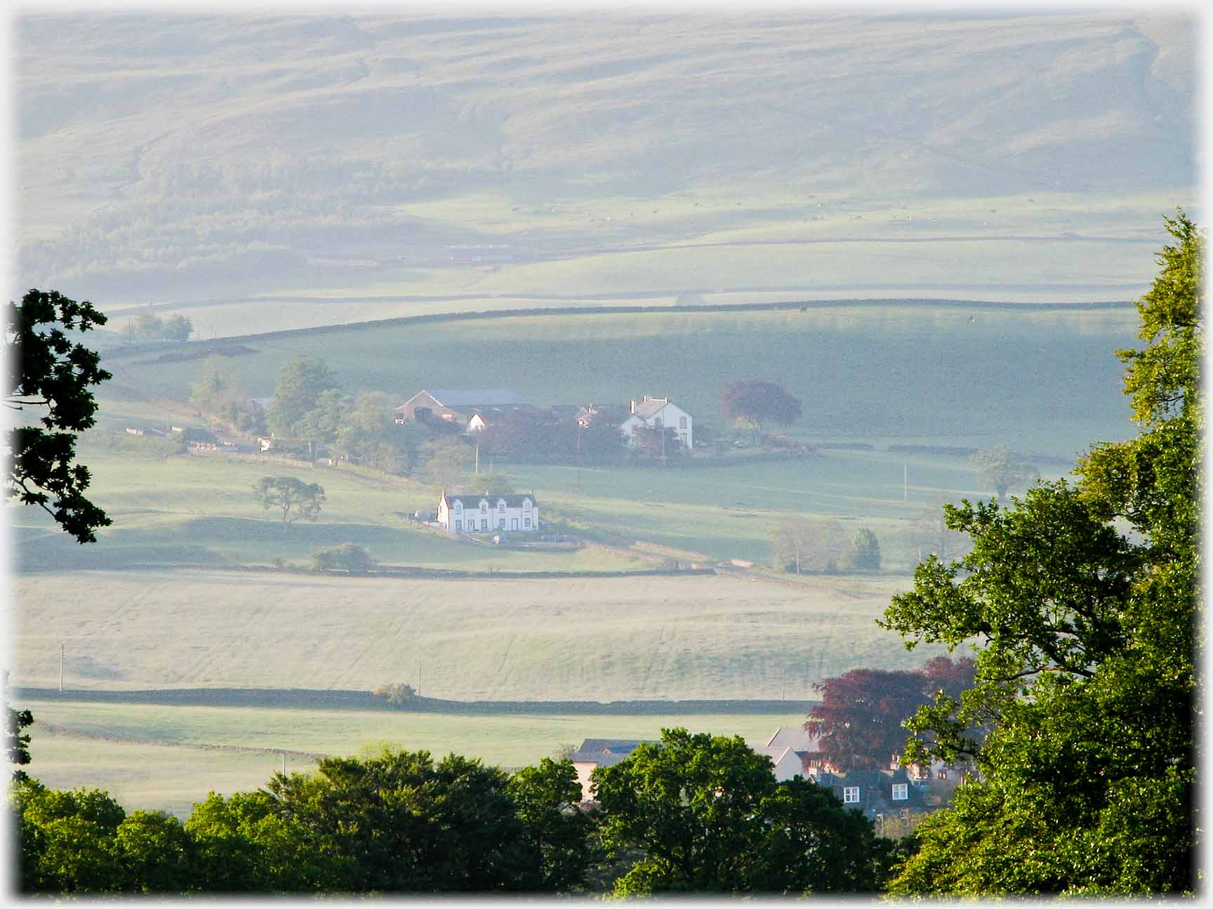 Fields cottages, farm and hillside.