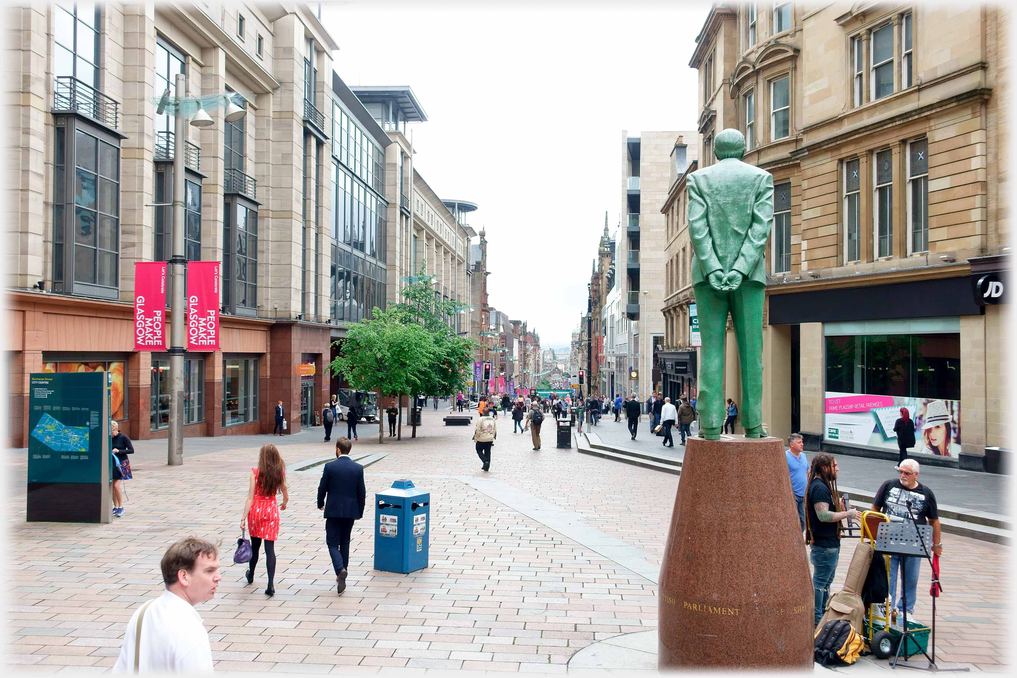 Looking down main pedestrianised street beside statue looking same way.