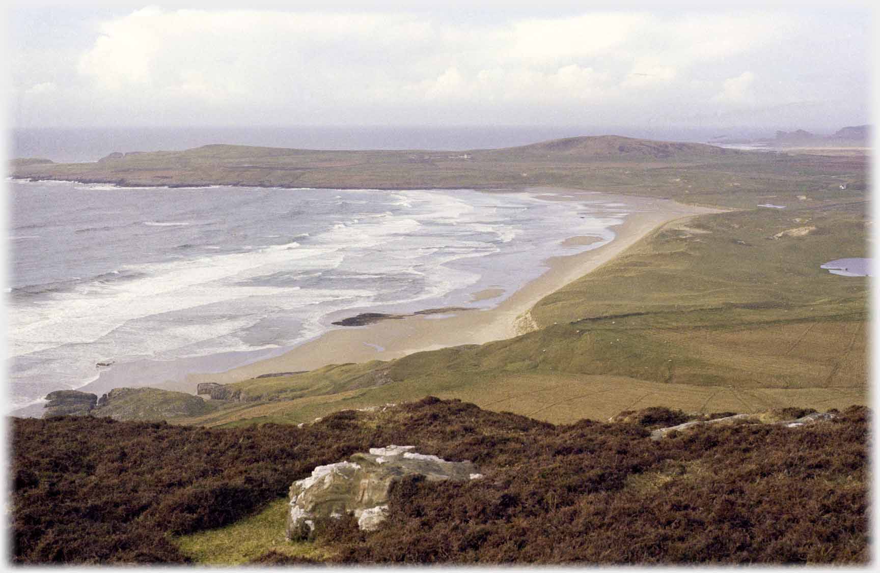 Lapping curves of receding waves on a sandy bay.