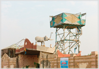 An elephant sculpture on a house.