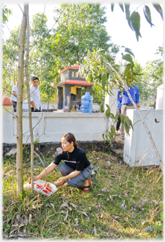 Lighting incense outside the tomb area for non-family members.