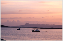 Fishing boats with iconic hill beyond.