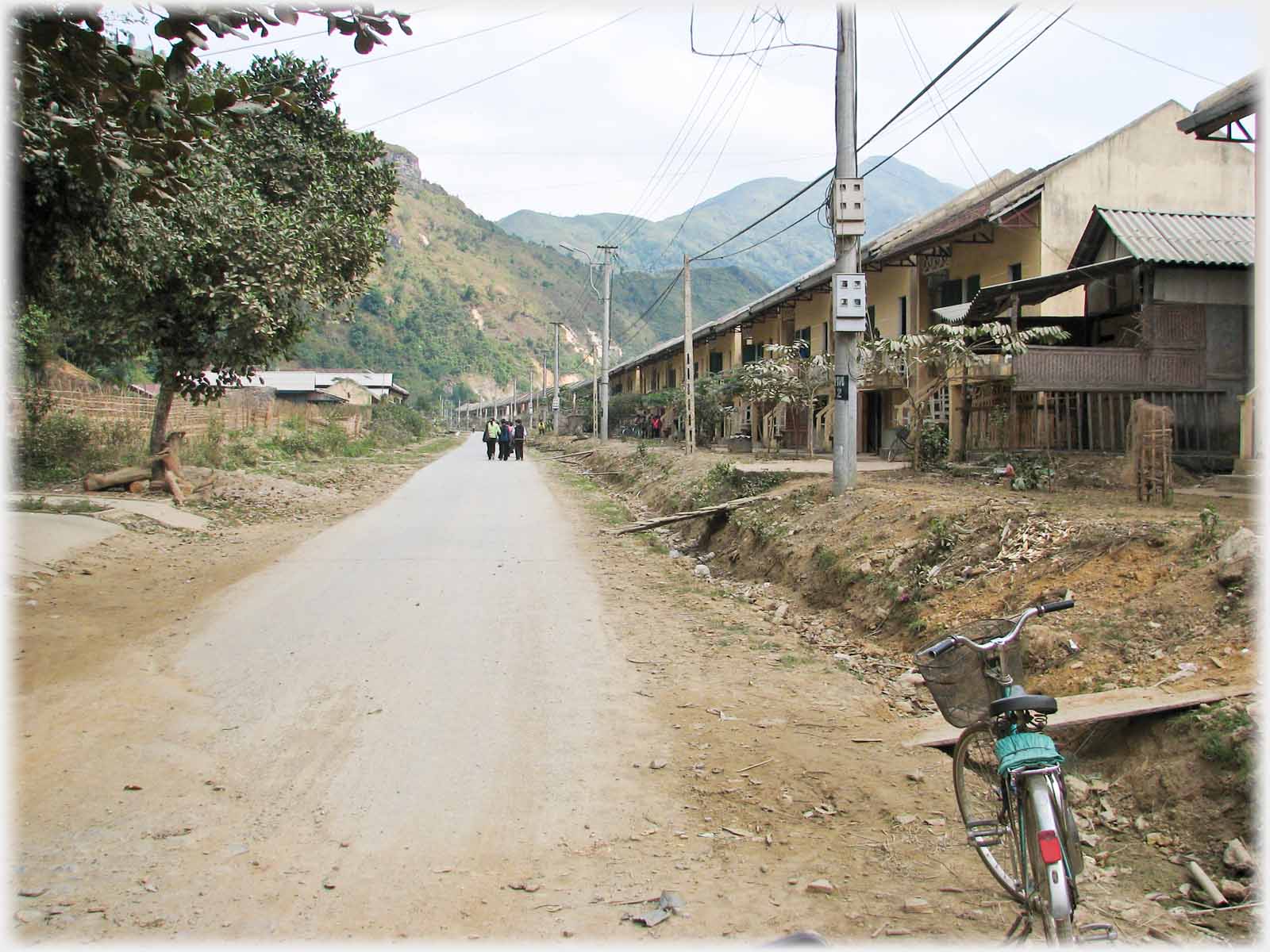 Road with line of houses on one side.