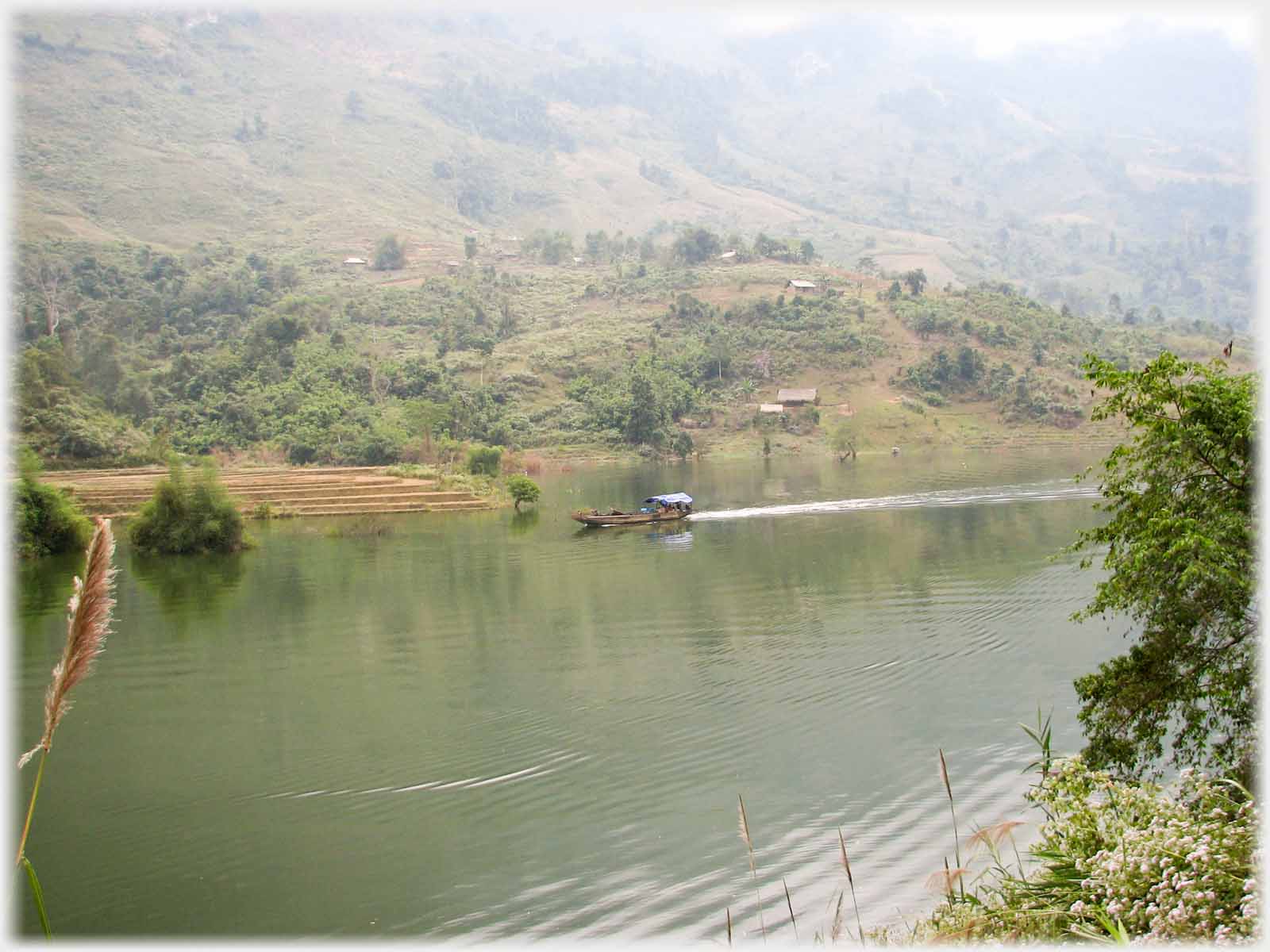 A boat seen across a river.