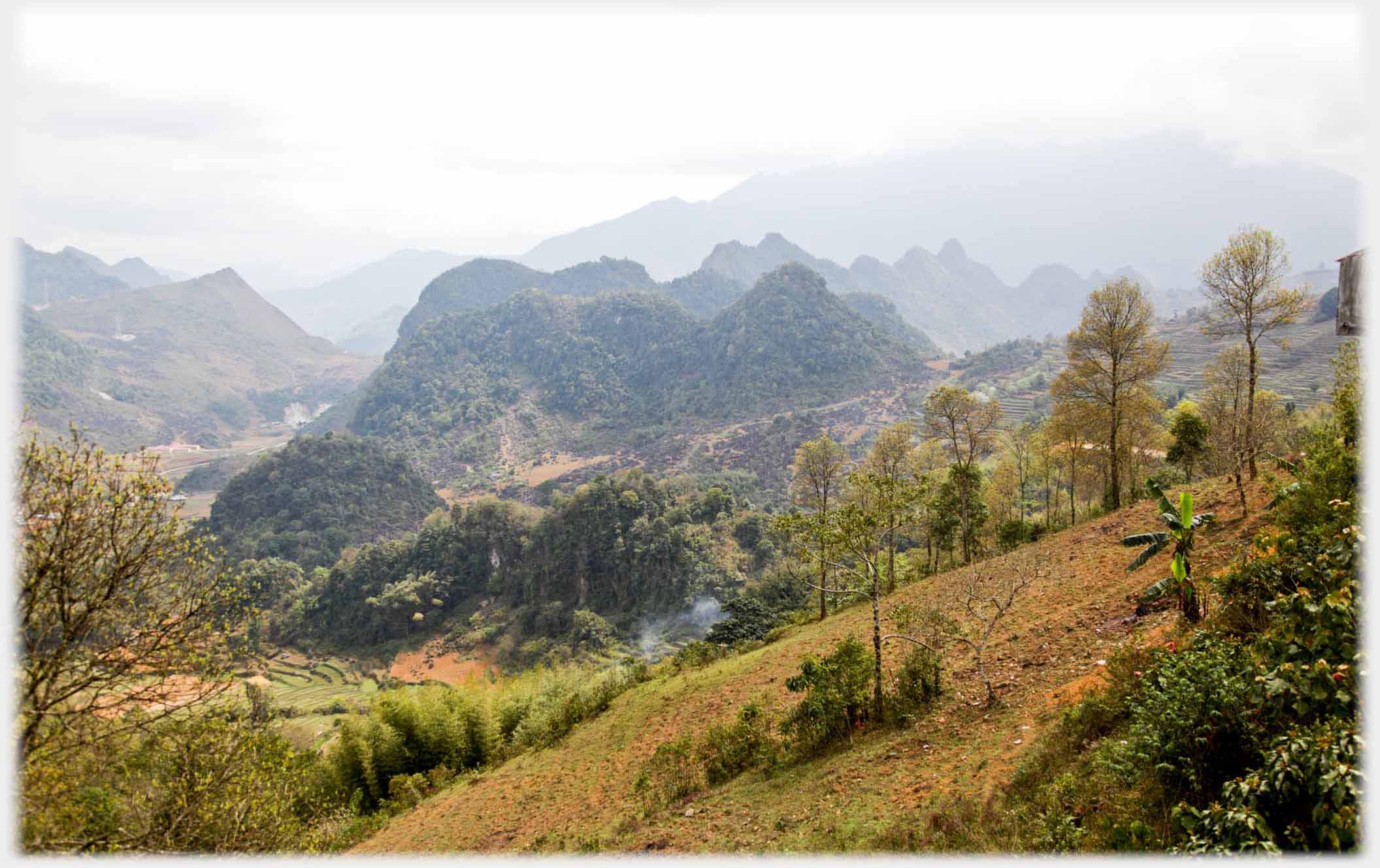 Wide valley with rugged karsts linked in small range in centre.