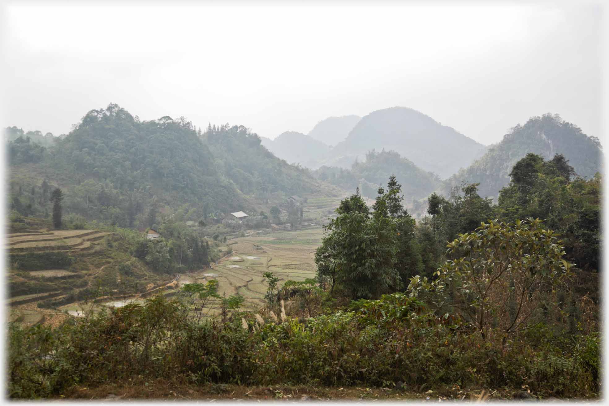 Small hills by flat fields.