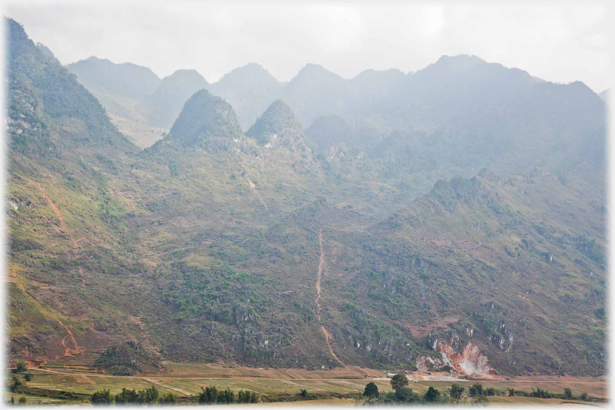 Looking across valley at line of peaks of karsts.