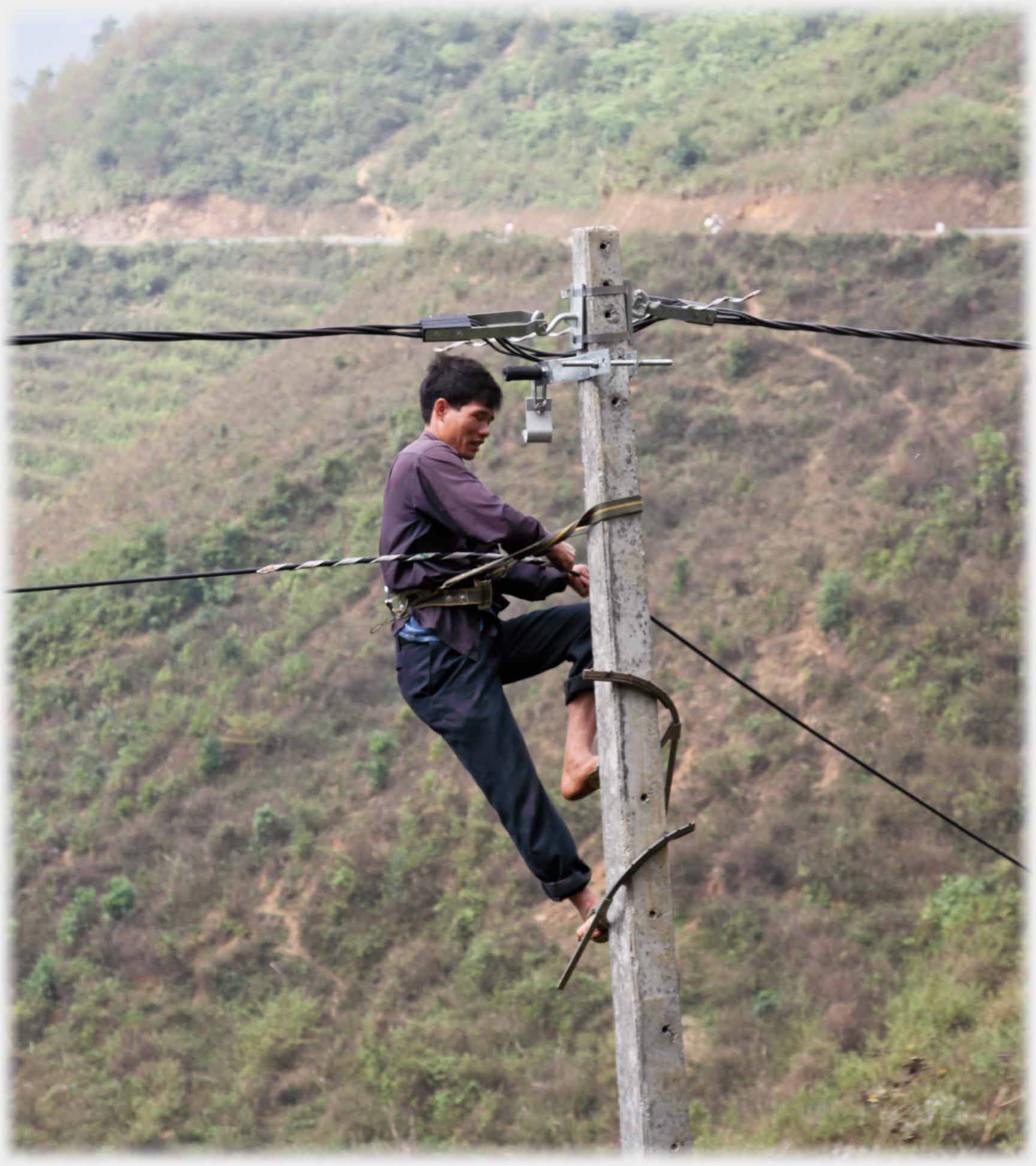Man at top of electric pylon with minimal ties.