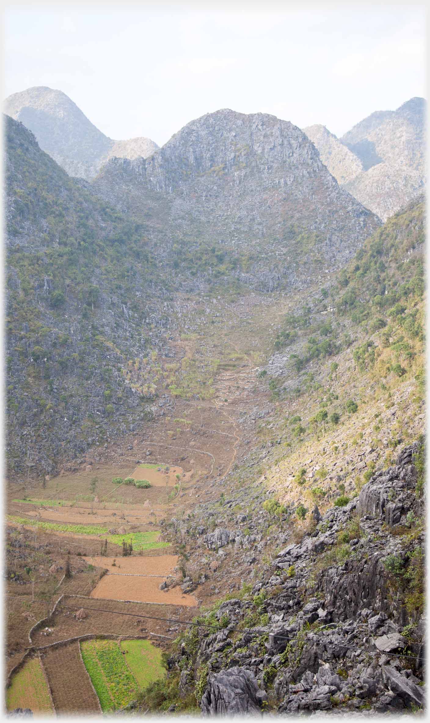 Looking down into steeply sided valley of scrub and rocks.