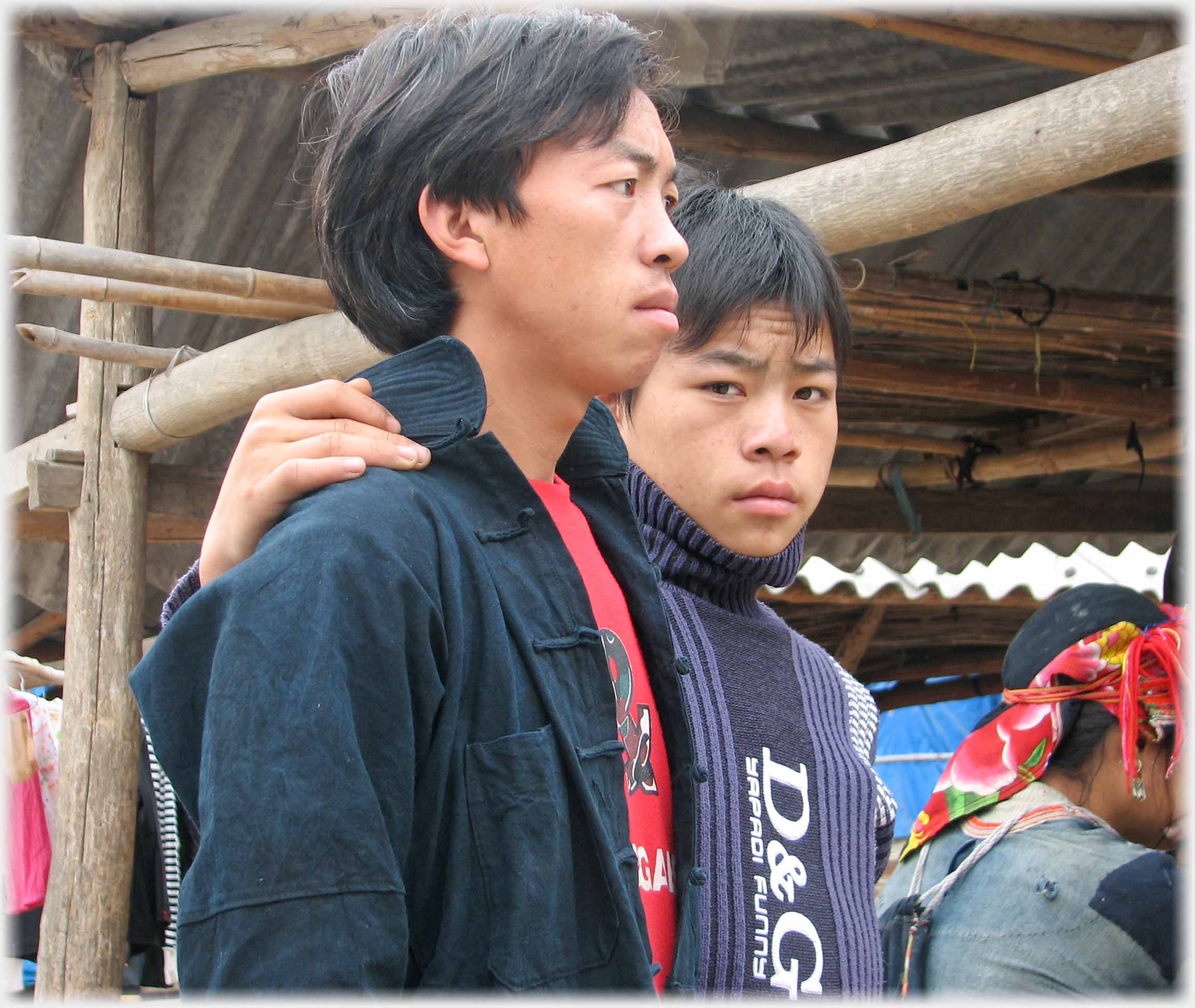 Two men one looking at camera with hand on others shoulder.