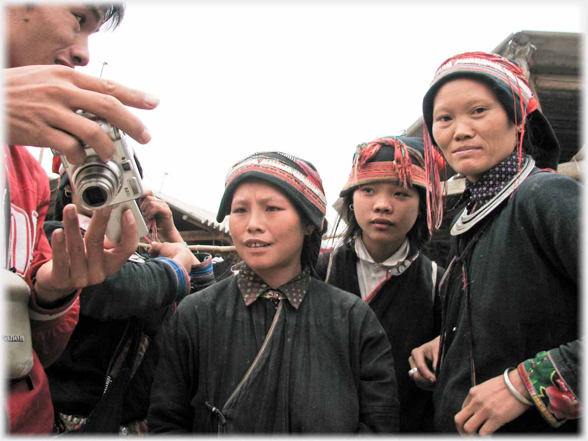 One woman looking at camera back another at me.