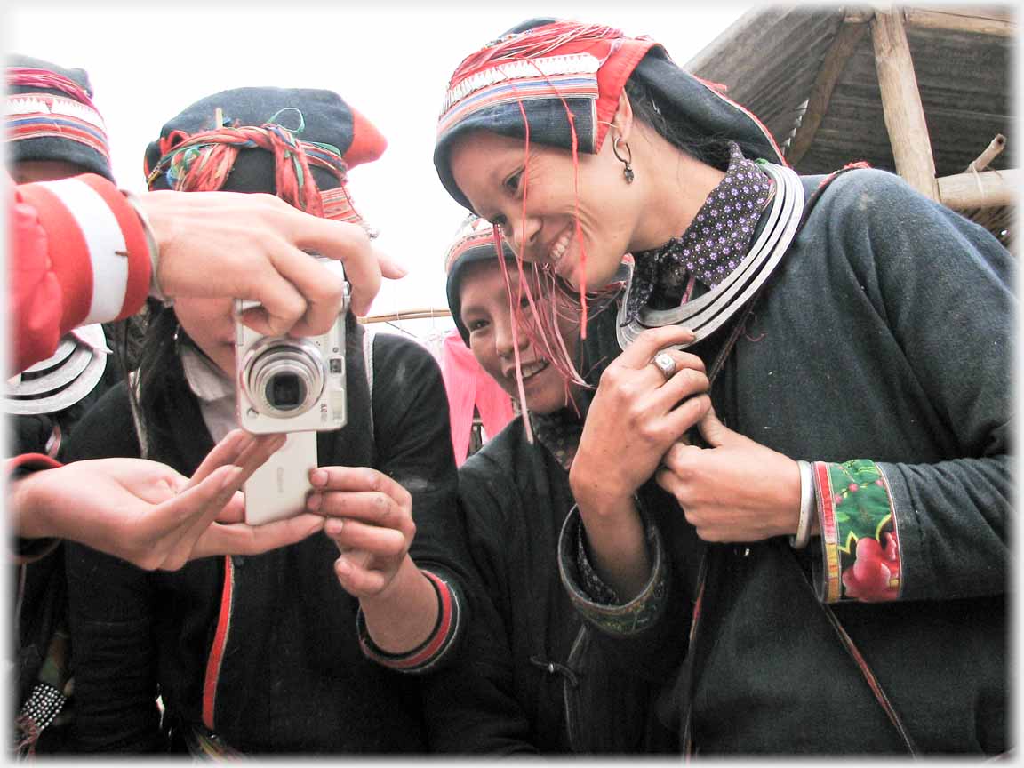 Woman leaning over and looking at camera back.