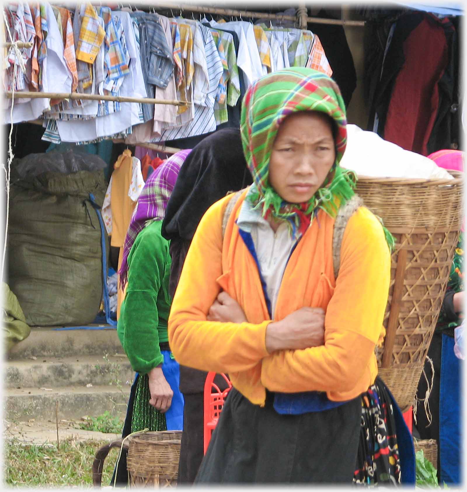 Woman with orange top looking down.