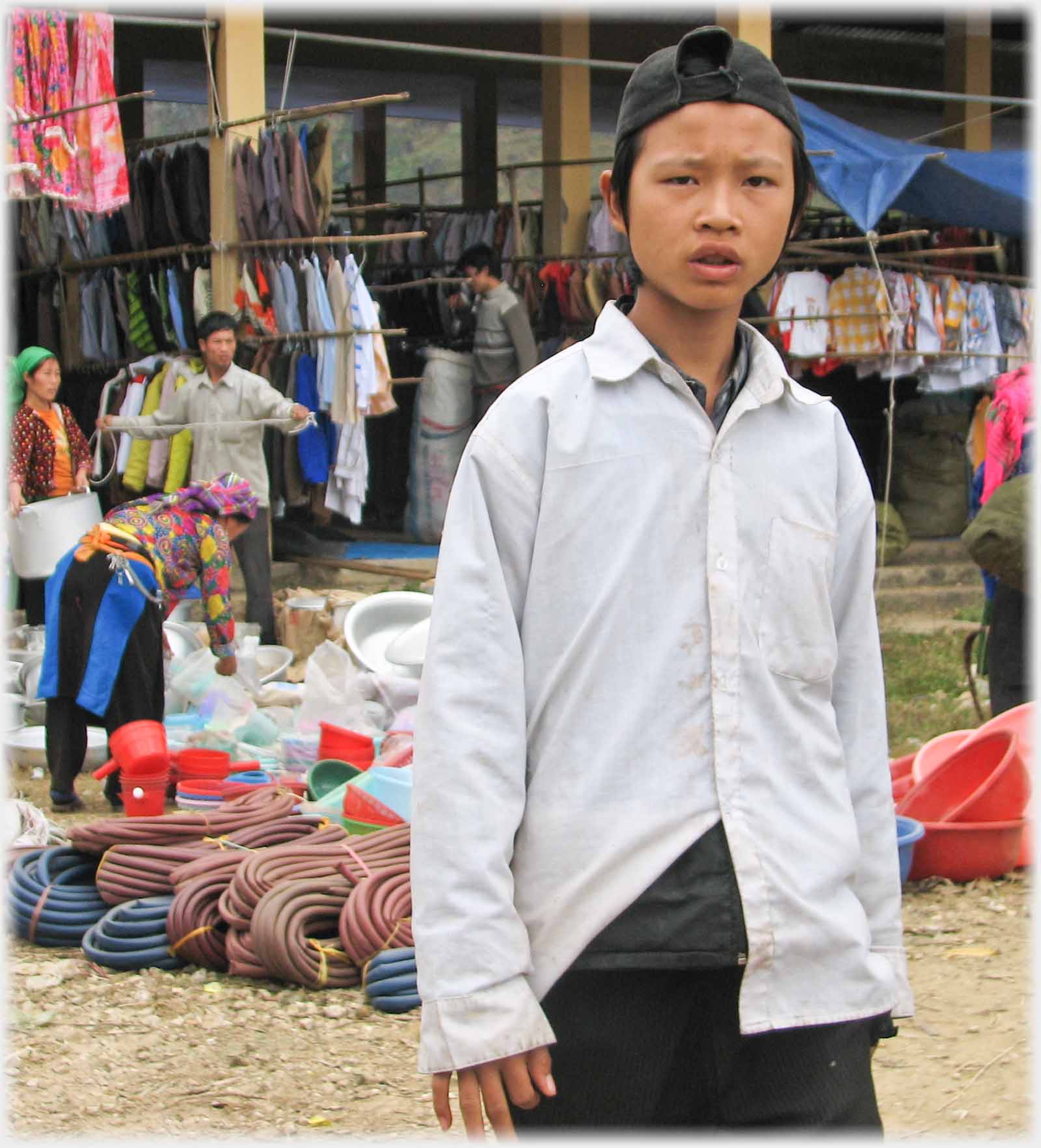 Boy in white shirt looking at camera.