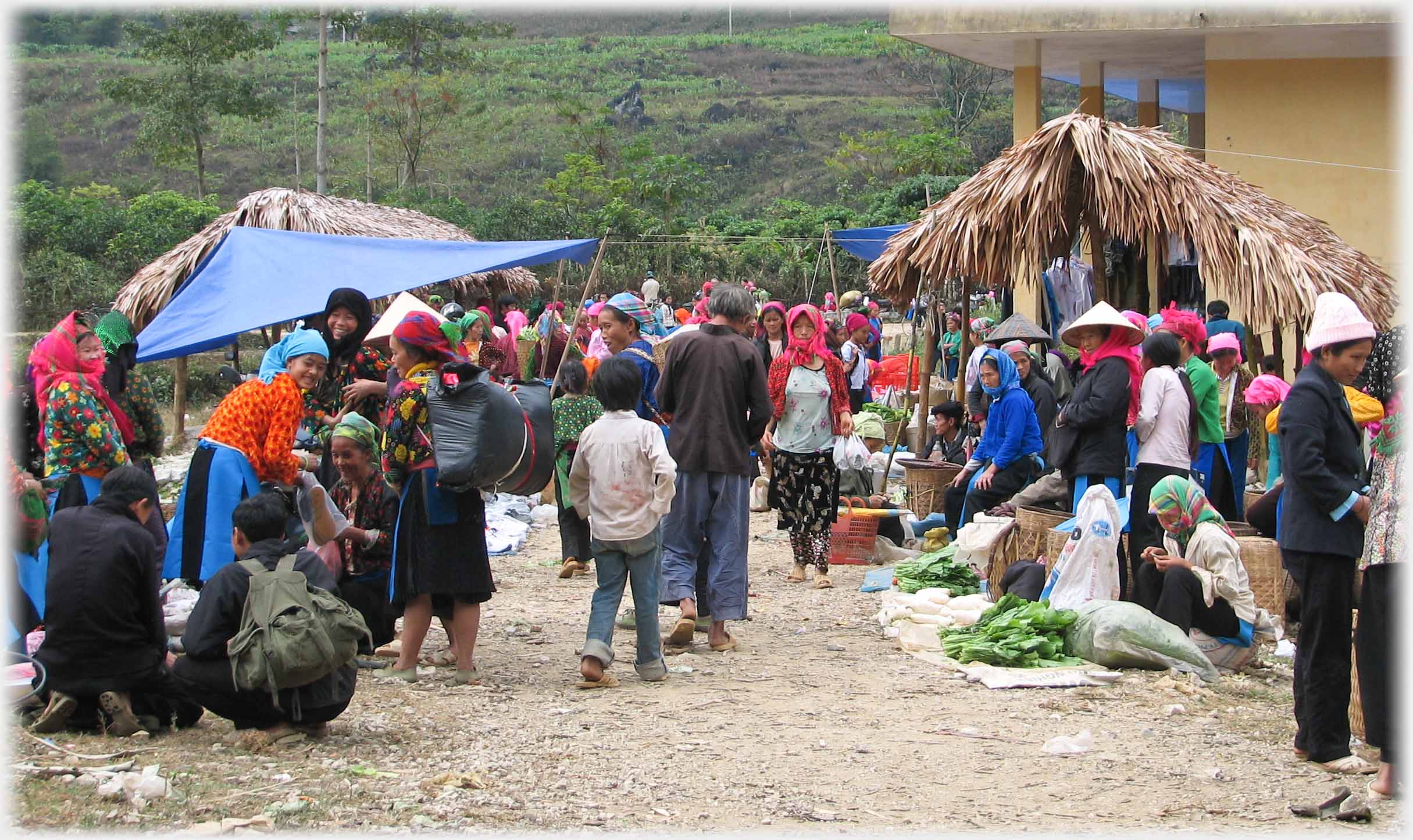 Pathway between stalls with sellers and buyers.