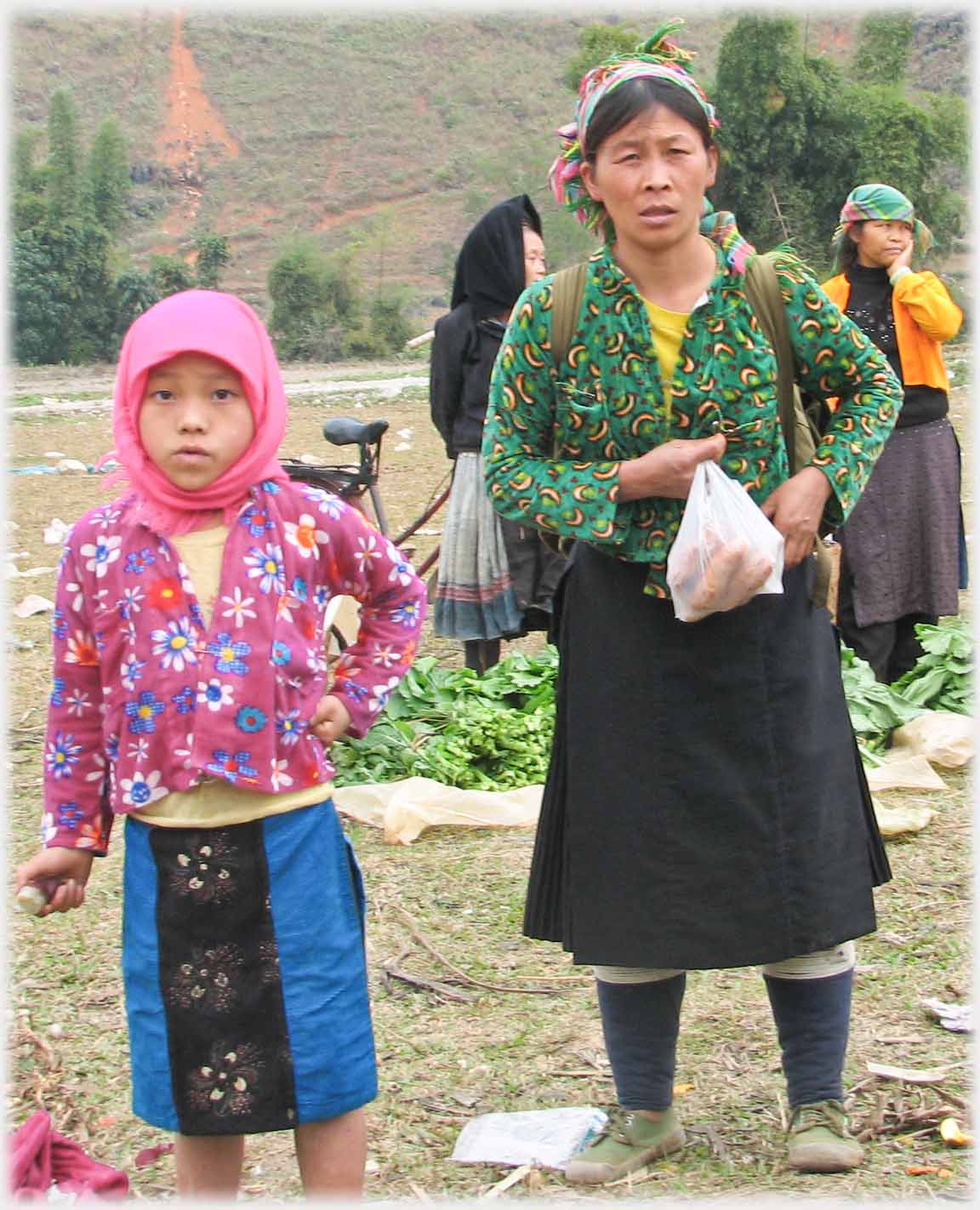 Woman and girl looking at photographer.