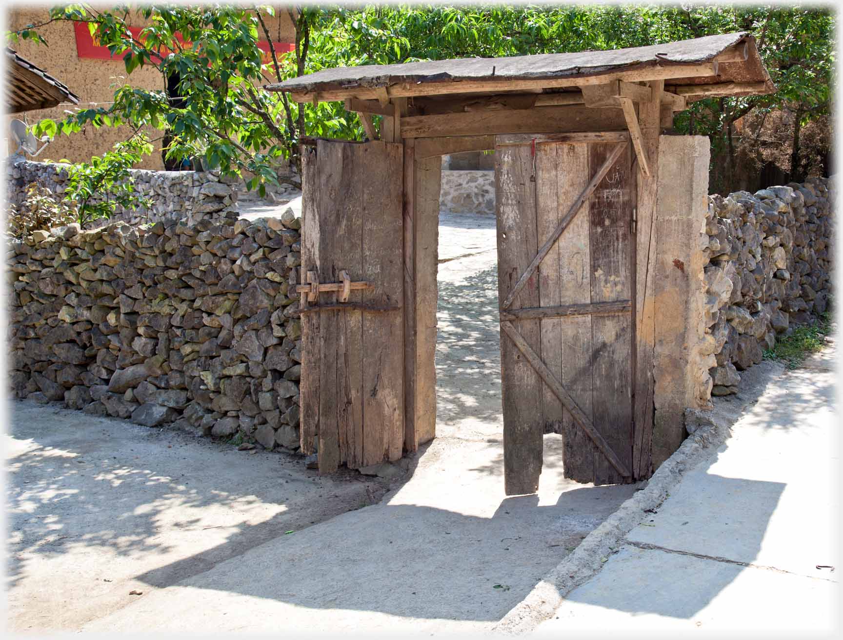 Double doored gate with simple roof.