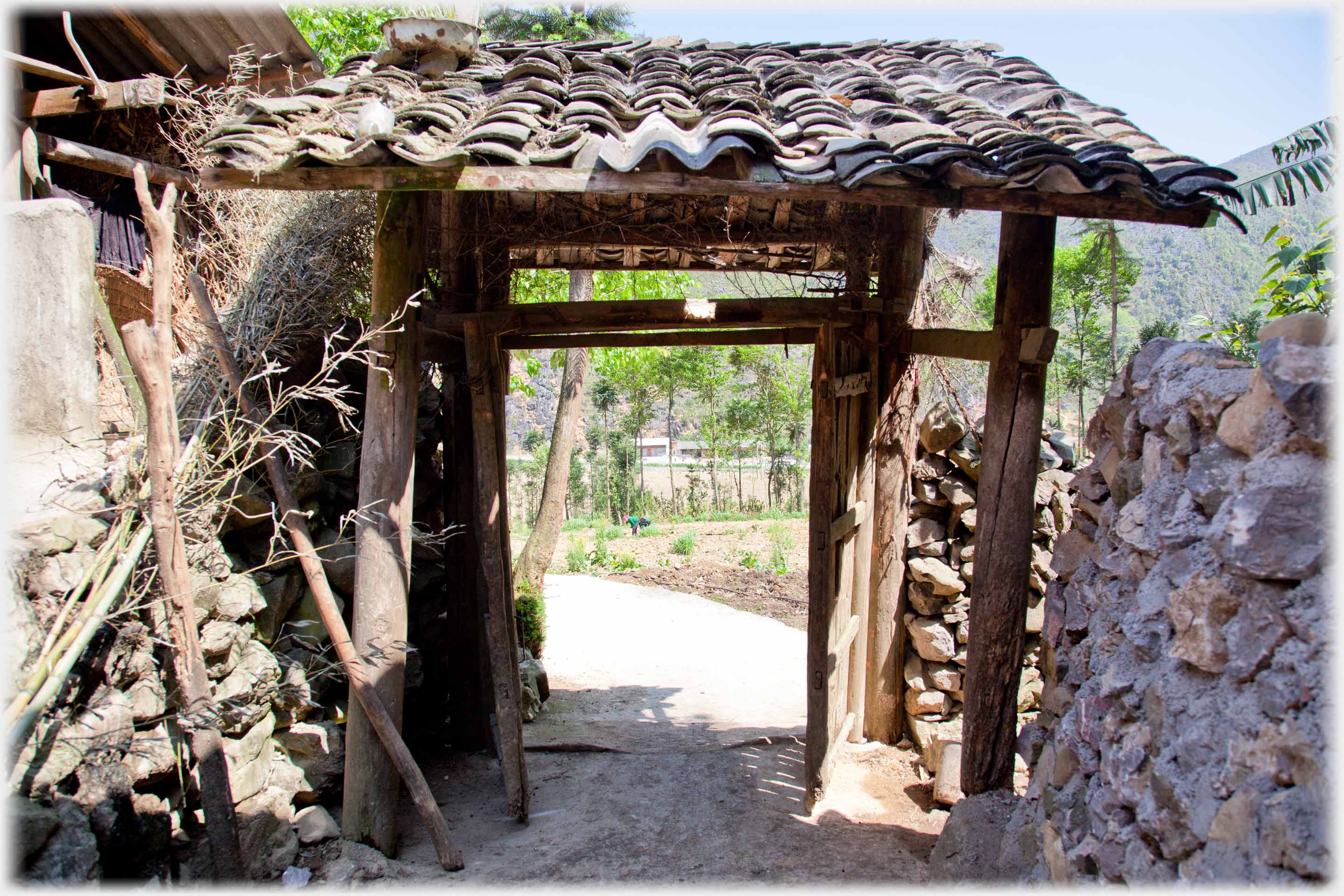 Rather delapidated double doored gate with pantiled roof.