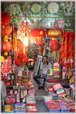 Looking into cave-like shop of lanterns and decorations.