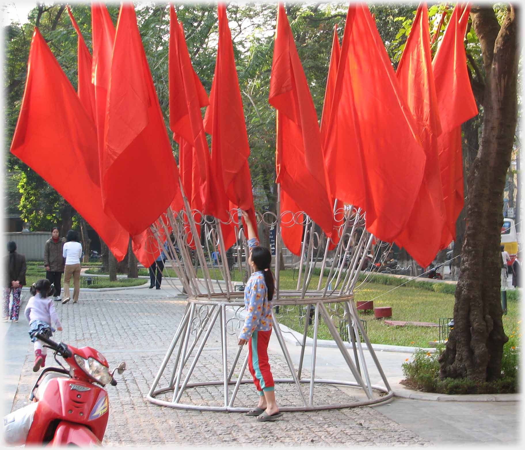 Woman reaching up and adjusting flags.